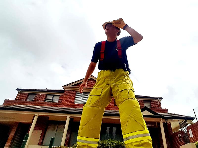 Firefighter Party Entertainer Sydney kids love, strikes a heroic pose before entering a Sydney kids party
